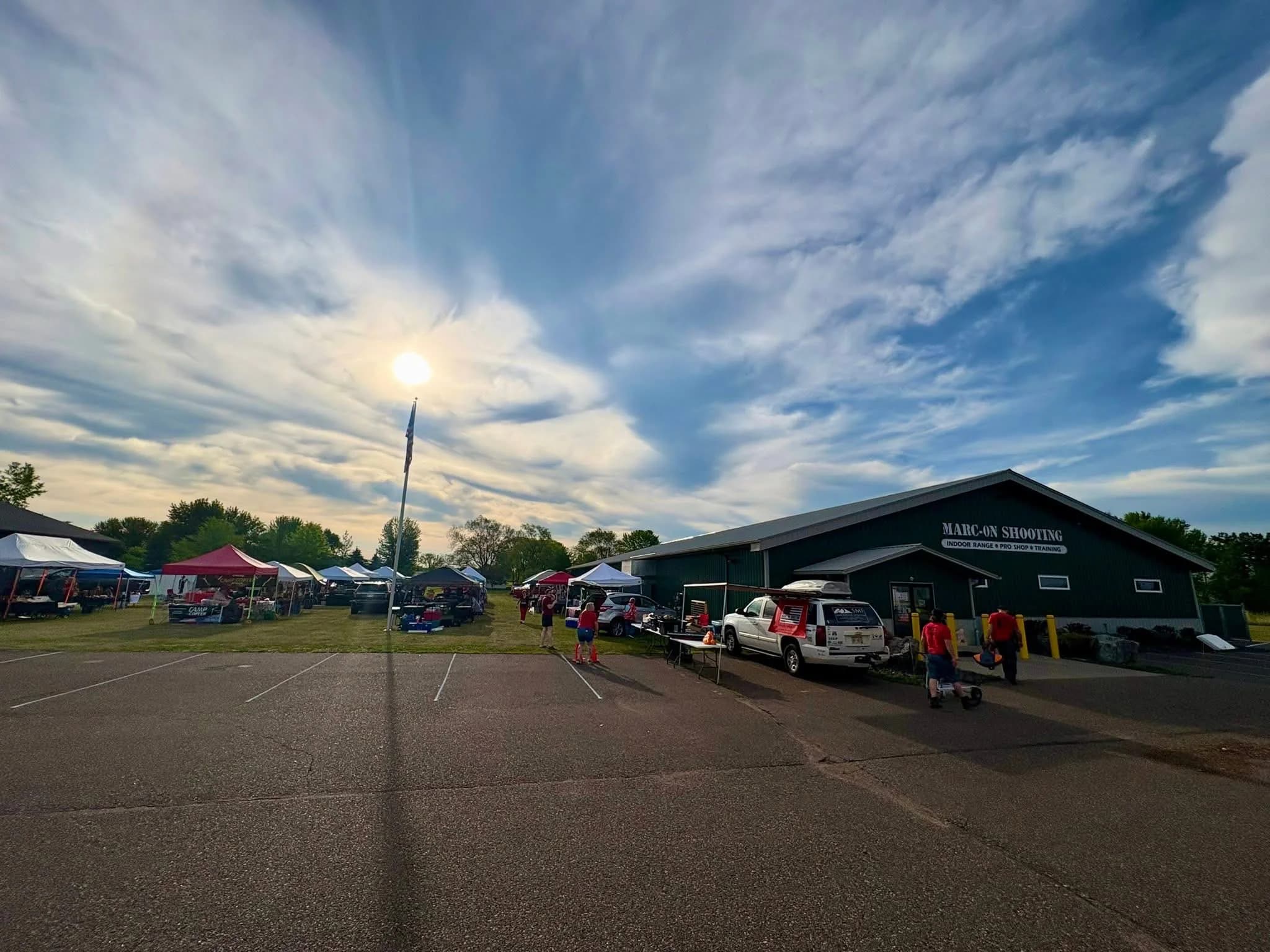 Marc-On Shooting’s building and vendor tents during a community event in Chippewa Falls