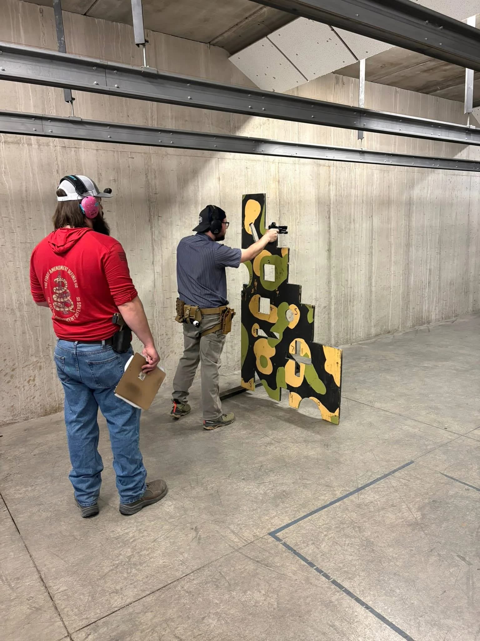 A Marc-On instructor supervising a shooter during an action-course exercise